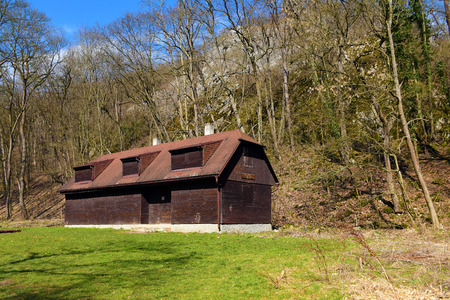 Wooden cottage in forest near village Srbskoの写真素材