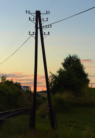 Poles near railway track in Okrisky town in summer eveningの写真素材