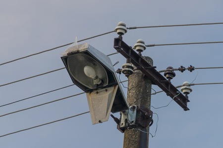 Electric post and lamp in the evening in summer timeの写真素材