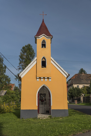 Yellow chapel in Sucha village in sunny dayの写真素材