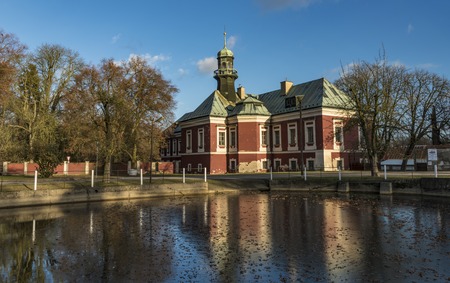 Castle near pond on square in Kokorin village in winter timeの写真素材