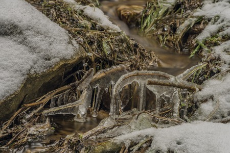Ice frosty winter creek on Jested hill in north Bohemiaの写真素材
