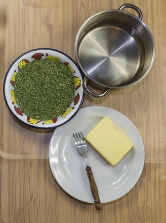 Medical marijuana leafs butter cooking with waterの写真素材