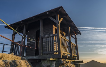 Wooden cottage on big rock in national park