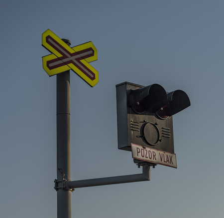 Railway crossing with sign in Czech republic in sunny spring morningの写真素材