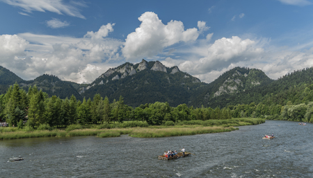 Boats on river Dunajec after rain with blue sky and white cloudsの写真素材