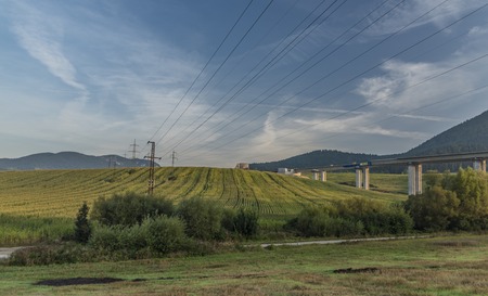 View near Ruzomberok town with big hill and electric wires in sunrise timeの写真素材