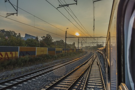 Fast train from Prague to south of Bohemia with sunrise and morning fogの写真素材