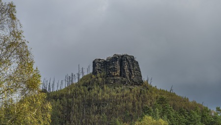 Havrani rock over Jetrichovice village in autumn dark dayの写真素材