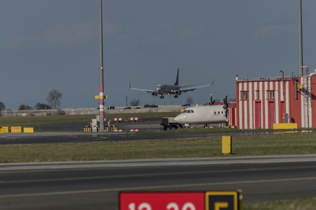 Landing of airplane in capital Prague in spring nice dayの写真素材