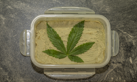 Cooking of marijuana green butter in hot water in kitchenの写真素材