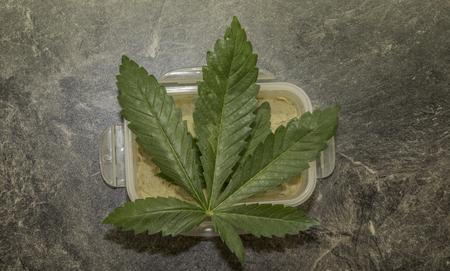 Cooking of marijuana green butter in hot water in kitchenの写真素材