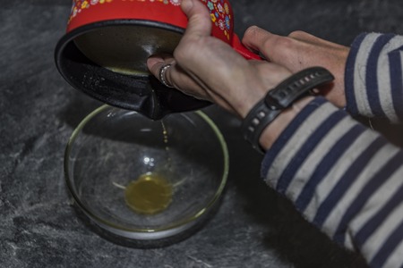 Cooking of marijuana green butter in hot water in kitchenの写真素材