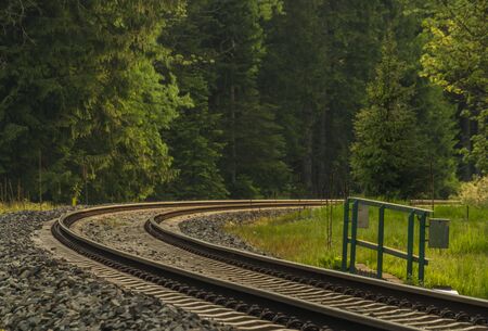 Railway track with sunset in spring color evening in national park in north Bohemiaの写真素材
