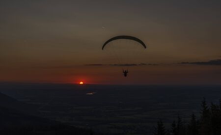 Paragliding from Javorovy hill over Trinec town with sunsetの写真素材