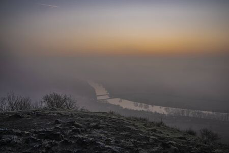 Sunrise time on Radobyl hill over valley of river Labe and Litomerice town in winter morningの写真素材