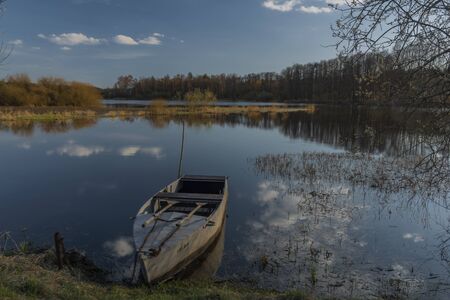 End of Lipno dam with dry grass in dry spring sunny day in Zlabek stationの写真素材