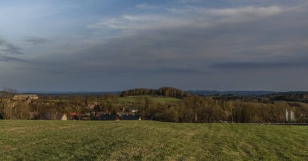 Roprachtice village in spring evening near sunset time with green meadows and pasture landsの写真素材
