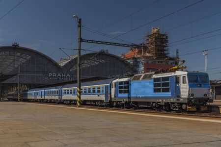 Blue electric fast train in station Prague in spring sunny blue sky dayの写真素材