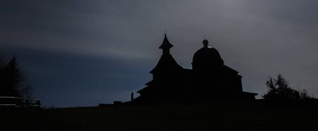Brown wooden old chapel on Radhost hill in Beskydy mountains in spring sunny morningの写真素材