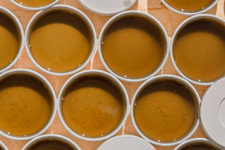 Production of marijuana medical salve with white gallipot and green leafs and grass