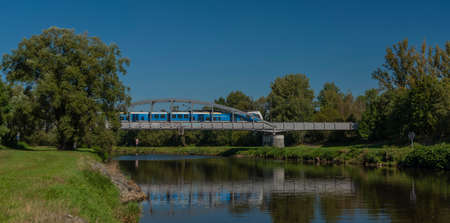 Railway bridge over Vltava river near Ceske Budejovice city in blue sky sunny color dayの写真素材
