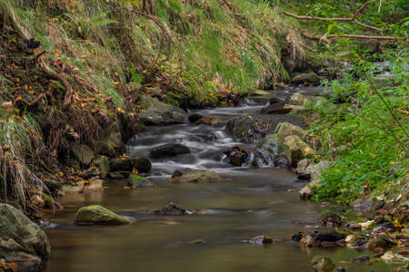 Krasetinsky creek near confluence with Kremzsky creek with small waterfall in autumn morningの写真素材