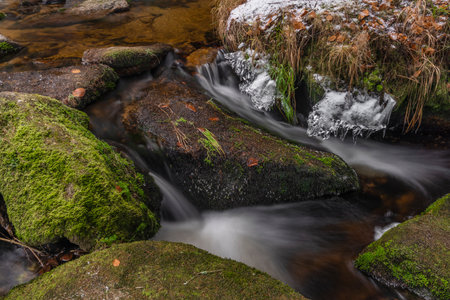 Konsky creek in National park Sumava with cascade and waterfall in winter sunny cold dayの写真素材