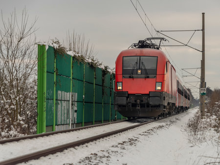 Fast train from Austria to Czech republic near Ceske Budejovice city in snowy cold day