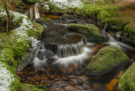 Konsky creek in National park Sumava with cascade and waterfall in winter sunny cold dayの写真素材