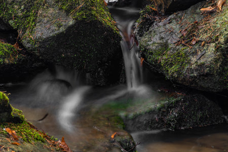 Small creek near Zlata Koruna village with green moss stone in winter cold day in south Bohemia regionの写真素材