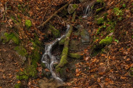 Small creek near Malse river with Doudlebsky waterfall in cold winter color day in south Bohemia