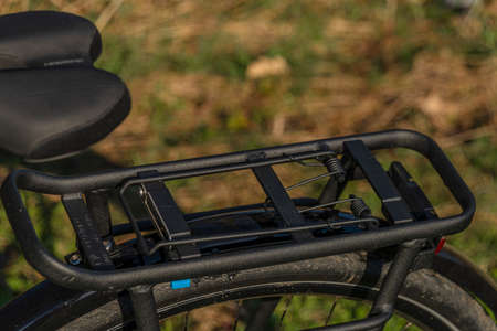 Black and gray electric bicycle in sunrise morning time on frosty field with yellow sun
