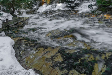 Kamenice creek in sunny frosty spring morning with Plattenfall fresh waterfall