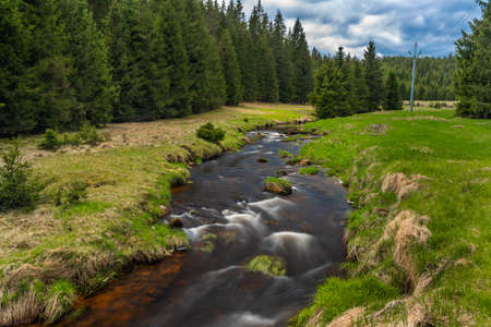 Rolava river with fresh meadows and forests in Krusne mountains