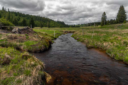 Rolava river with fresh meadows and forests in Krusne mountains