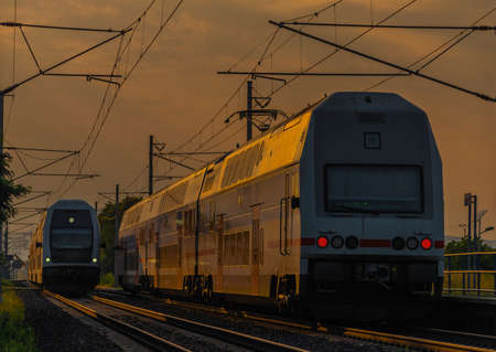 Trains and small whistle stop Olesko in central Bohemia in sunset orange eveningの写真素材