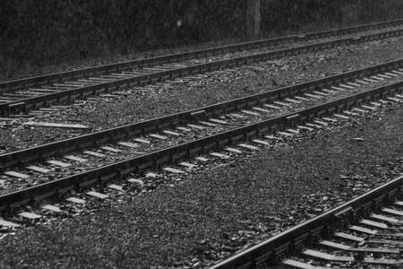 Electric engine and blue coach from window in dark rainy summer day