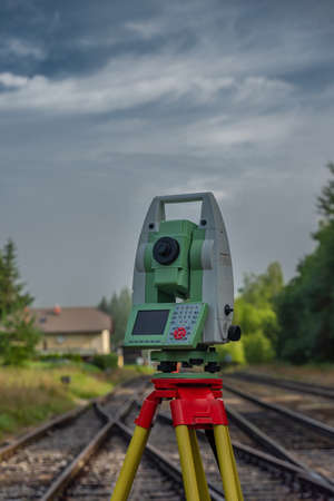 Machine for surveyors with blue sky and green trees in sunny color day
