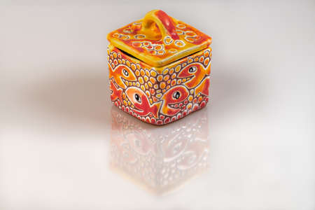 Color porcelain tin with cap on white background with nice reflectionの写真素材