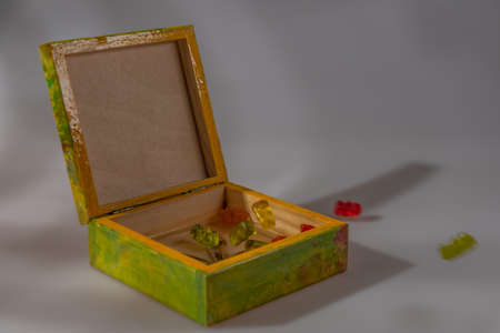 Color wooden box with cap on white background with nice reflection and color fresh candyの写真素材