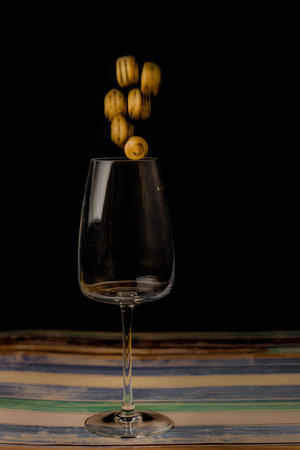 Transparent dirty glass with color dice on color wooden tableの写真素材