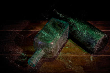 Old color glass bottle with fresh light and old dirty cobwebの写真素材