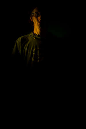 Black hair man near dark black old background