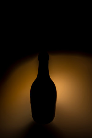 Old color dirty glass bottle with fresh light and black backgroundの写真素材