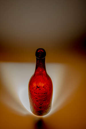 Old color dirty glass bottle with fresh light and black backgroundの写真素材