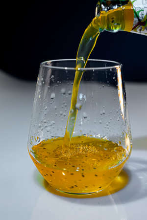 Blue light with mango juice and transparent clean glassの写真素材