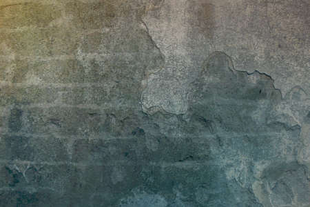 Old stone brick gray wall with very dry old stucco plastering