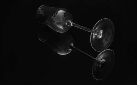 Black background and glass bottles with reflection on black tableの写真素材