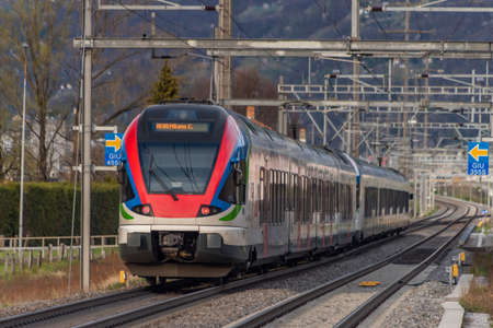 Red high speed train near Bellinzona old town in south Switzerland